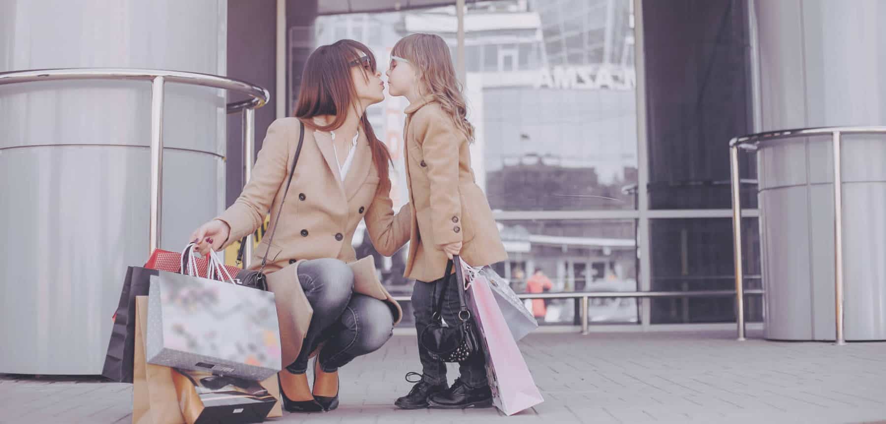 mother and daughter with shopping bag in a city UHWC3UX scaled 1